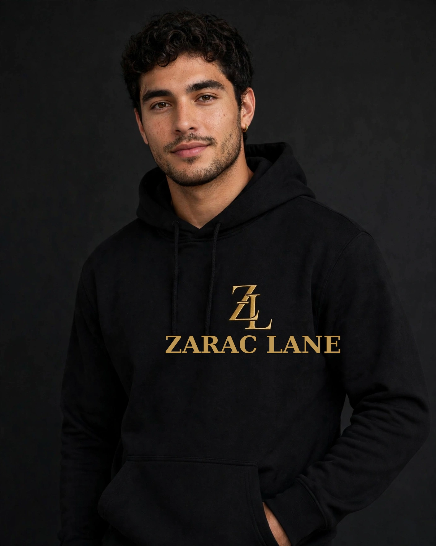 Person in a clean studio wearing the black hoodie with gold ZL emblem